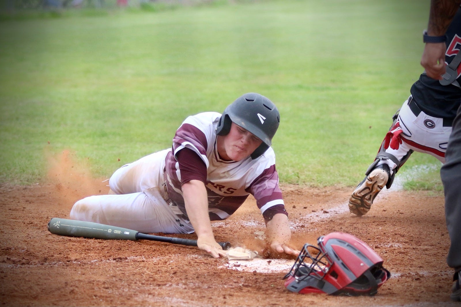Merryville's Causey Owen slides in safely across home during a game earlier this season. Owen was named the District 4-1A Most Valuable Player this season after batting .576 with 19 RBIs.
