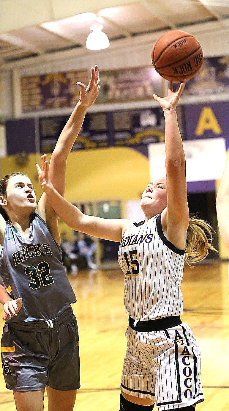Anacoco's Bailey Davis (15) goes up for a shot against Hicks' forward Maci Charrier in a Lady Pirate win over the Lady Indians, 54-28