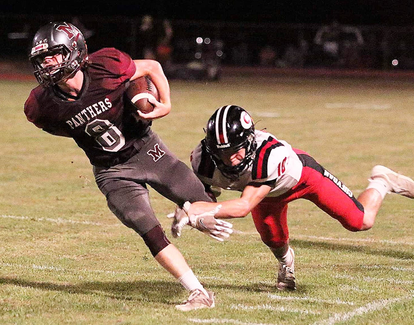 Merryville running back Dakota Thompson (8) attempts to break away from a tackle along the sideline during the Panthers' loss to the Gueydan.