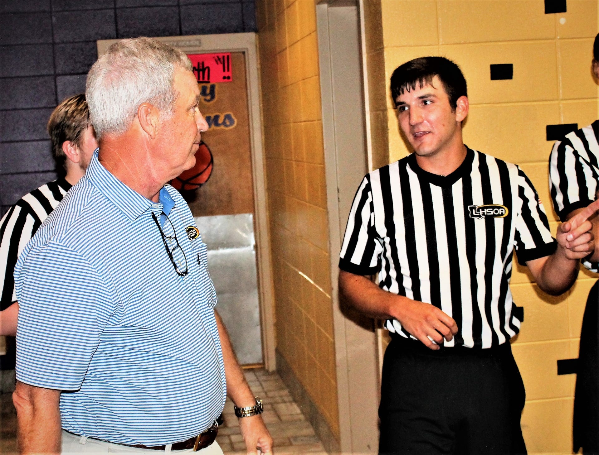 Veteran referee Dr. John Fletcher (left) talks over some officiating techniques with former Anacoco all-state Brent Cosio, a new official with the Leesville Basketball Officials Association, at a recent official's scrimmage at Anacoco High School. Cosio will be one of two LBOA officials to take part in the upcoming TIPoff Classic on Oct. 30 at Alexandria Senior and Pineville High Schools.