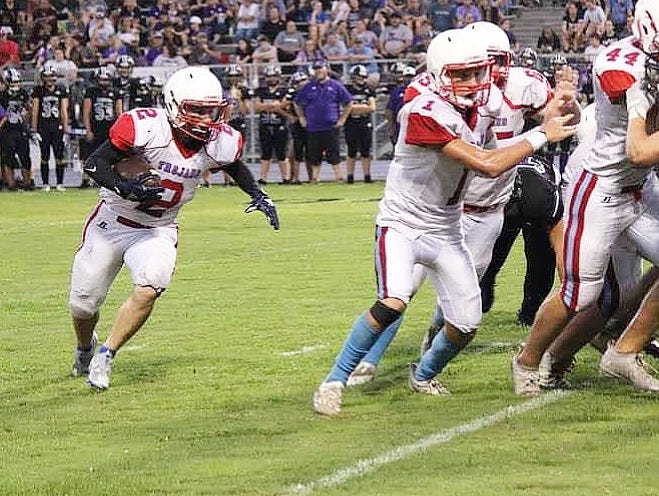 EBHS running back Kane Atkinson (2) rushed for 150 yards and three touchdowns in the Trojans' 64-50 win on Friday over the Elton Indians.